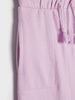 Close-up of a light purple pants with a drawstring on a white background