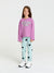 Young girl wearing a pink sweatshirt with 'YOU GO GIRL' text and light blue pants with black polka dots on a white background.