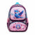 A pink and purple patterned school backpack with a blue bird illustration on the front pocket, placed on a beige tiled floor.