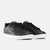 Black Reebok sneakers with white soles on a light gray background