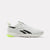 A white Reebok athletic sneaker with black vector stripes and a bright neon yellow-green outsole accent, shown in a side profile on a light gray background.