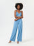 Woman wearing a blue jumpsuit on a white background