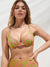 A woman modeling a bright pink and lime green floral-patterned bikini top and matching high-waisted bottoms against a white background.