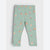 A pair of children's leggings in a light sage green color, featuring an all-over festive print of gingerbread men, reindeer, candy canes, and small red hearts.