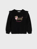 Black sweater with a dog graphic and text on a light gray background