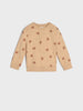 Beige sweatshirt with small patterns on a light gray background