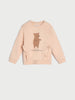 Pink sweatshirt with a bear design on a light gray background