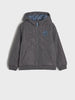 Gray quilted jacket with a logo on a light gray background