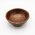 A round wooden bowl with a rich dark brown finish and visible wood grain, photographed from a top-down angle on a clean white background.