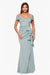 Woman wearing a light blue off-shoulder gown with ruffle details on a white background