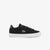 Black sneaker with green logo on a white background