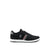 A black low-top sneaker with a white midsole, featuring a gray heel tab, a diagonal red and white stripe on the side, and a silver embroidered polo player logo on the side panel.