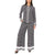 A woman modeling a matching two-piece lounge set featuring a long-sleeve button-front top and wide-leg pants, both in a black and white geometric pattern with striped cuffs and hems.