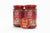 Two jars of Taj pizza sauce with a '1+1 Free' label on a newspaper background.