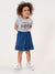 Child wearing a gray t-shirt with text and a blue denim skirt on a white background