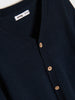Navy blue cardigan with button details and 'ainsay' brand label.