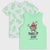 Two children's short-sleeve tops on a light gray background: a mint green sleeveless tank top in front with a watermelon graphic and the words 'TAKE IT EASY SUMMER TIME,' and a white T-shirt behind covered in repeating green 'TAKE IT EASY' text.