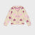 A cream-colored knit cardigan with a pattern of pink and purple hearts, featuring a scalloped pink trim along the neckline, cuffs, and hem.