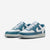 Pair of green and white sneakers on a white background
