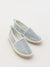Pair of light blue espadrilles on a white background