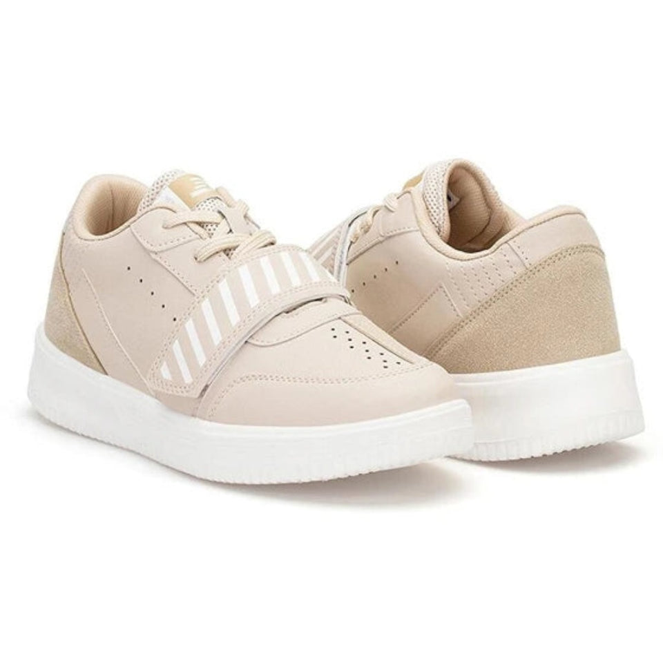 A pair of low-top platform sneakers in a light beige colorway, featuring a wide white platform sole, beige suede panels, and a white-and-beige striped strap across the side, shown against a plain white background.