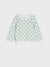 Green and white checkered sweater on a light gray background