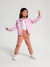Child wearing a pink jacket and pants on a white background