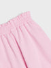 Close-up of pink pants with an elastic waistband on a light gray background