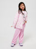Young girl wearing a pink outfit with a patterned top and pants on a white background