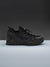 Black sneaker on a gray background