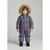 A young child wearing a dark floral snowsuit with a brown faux-fur trimmed hood, standing against a light gray studio background.