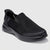 A black slip-on mesh sneaker with a thick black sole, shown from a three-quarters angle on a light gray background.