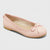 A single light pink ballet flat shoe with a small bow on the toe, shown from a three-quarters angle against a light gray background.