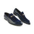 A pair of men's loafers in navy blue, featuring a mix of patent leather and velvet textures, accented with gold-tone horsebit hardware on the vamp, set against a plain white background.