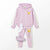 A children's two-piece tracksuit in light pink, featuring a zip-up hoodie with reflective silver sleeves and a Pikachu graphic on the chest, matching pink joggers with a vertical Pikachu print and white side stripes, plus a pair of white socks and matching pink sneakers, laid out on a white background.