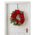 A festive Christmas wreath with red poinsettias, pinecones, green leaves, and red berries hanging on a white paneled door.
