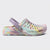 A single pastel tie-dye clog shoe with a lavender strap and multicolor pattern of pink, yellow, green, and blue, shown against a light gray background.
