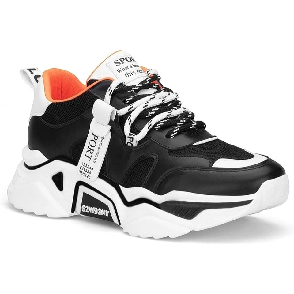 A black and white chunky platform sneaker with a bright orange lining, featuring white laces, a white sole, and a white hanging tag that reads 'FOXT'.
