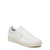 A white leather low-top sneaker with white laces, a white padded collar, and a thick off-white rubber sole, shown from a three-quarters angle on a white background.