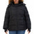 A woman wearing a black puffer jacket with a full front zipper, zippered hand pockets, and a high collar, paired with blue jeans against a plain white background.