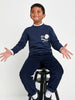Child wearing a navy blue outfit with a white logo on a white background