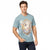 A man wearing a light blue Guess t-shirt with a large vintage-style Los Angeles graphic on the front, paired with dark blue jeans, against a plain white background.