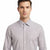 A man wearing a light gray and white micro-patterned button-down shirt, shown from the chest up against a plain white background.