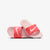 A pair of Nike slide sandals in pink and coral red, displayed on a clean white background.