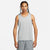 Man wearing a gray Nike tank top and shorts on a white background