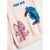 A close-up of a light pink sweatshirt featuring cartoon character prints of Stitch in blue and pink, with the text 'HUG ME' printed in blue at the top.