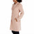 A woman wearing a light blush pink mid-length coat with notch lapels and front patch pockets, shown in a side profile against a plain white background.