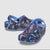 A pair of light blue Croc-style clogs with a vibrant multicolor butterfly print on a light gray background.