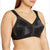 A close-up of a woman wearing a black sheer floral lace bra with mesh panels and wide shoulder straps, shown against a plain white background.