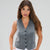 A woman modeling a sleeveless gray vest with a V-neck and black buttons, paired with white pants, against a light gray studio background.